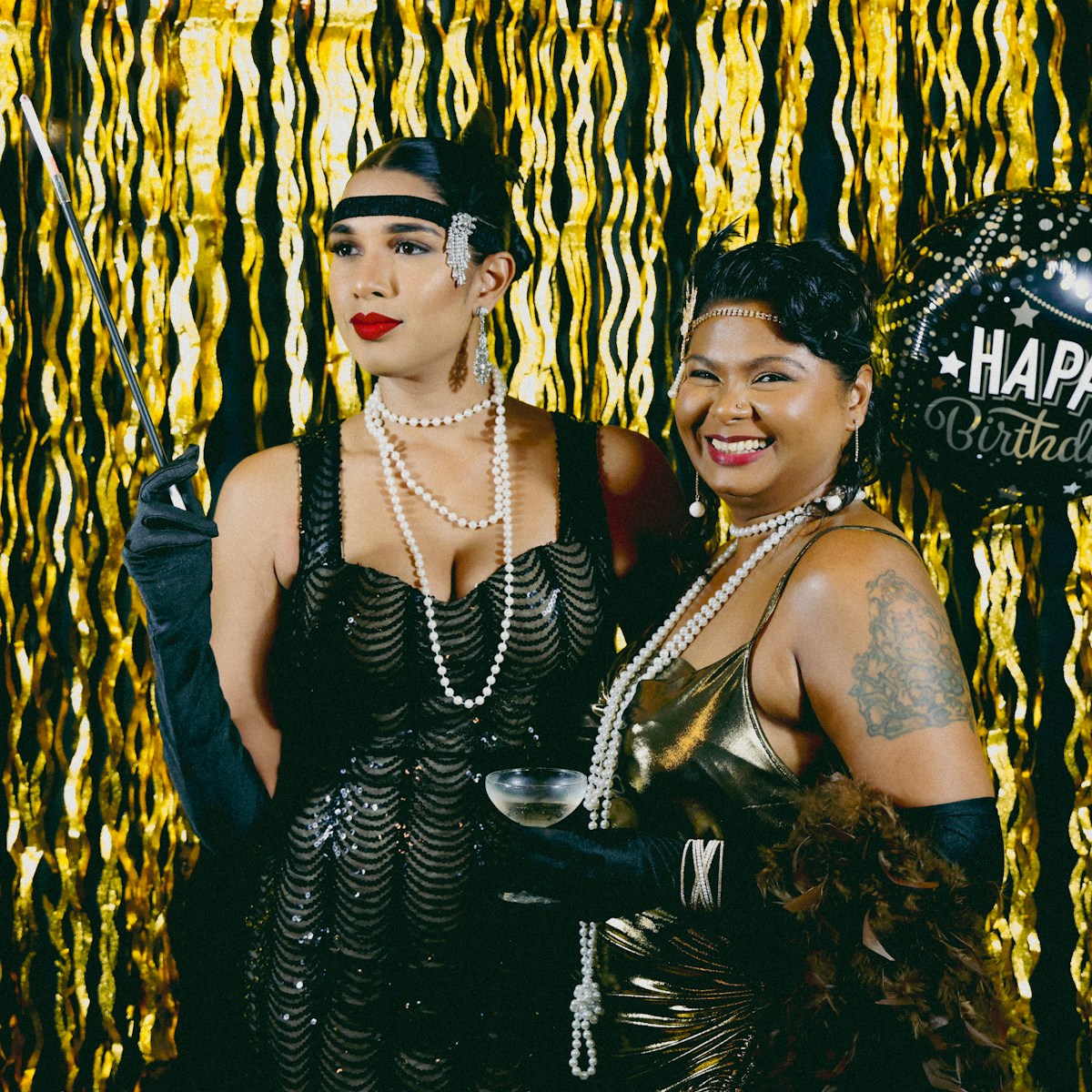 Two women dress up for a roaring twenties party.